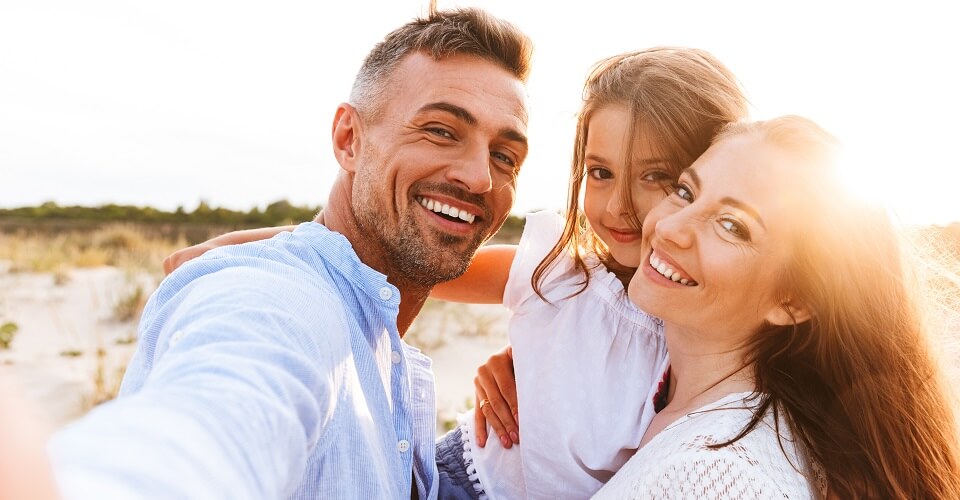 A couple with a girl are being photographed